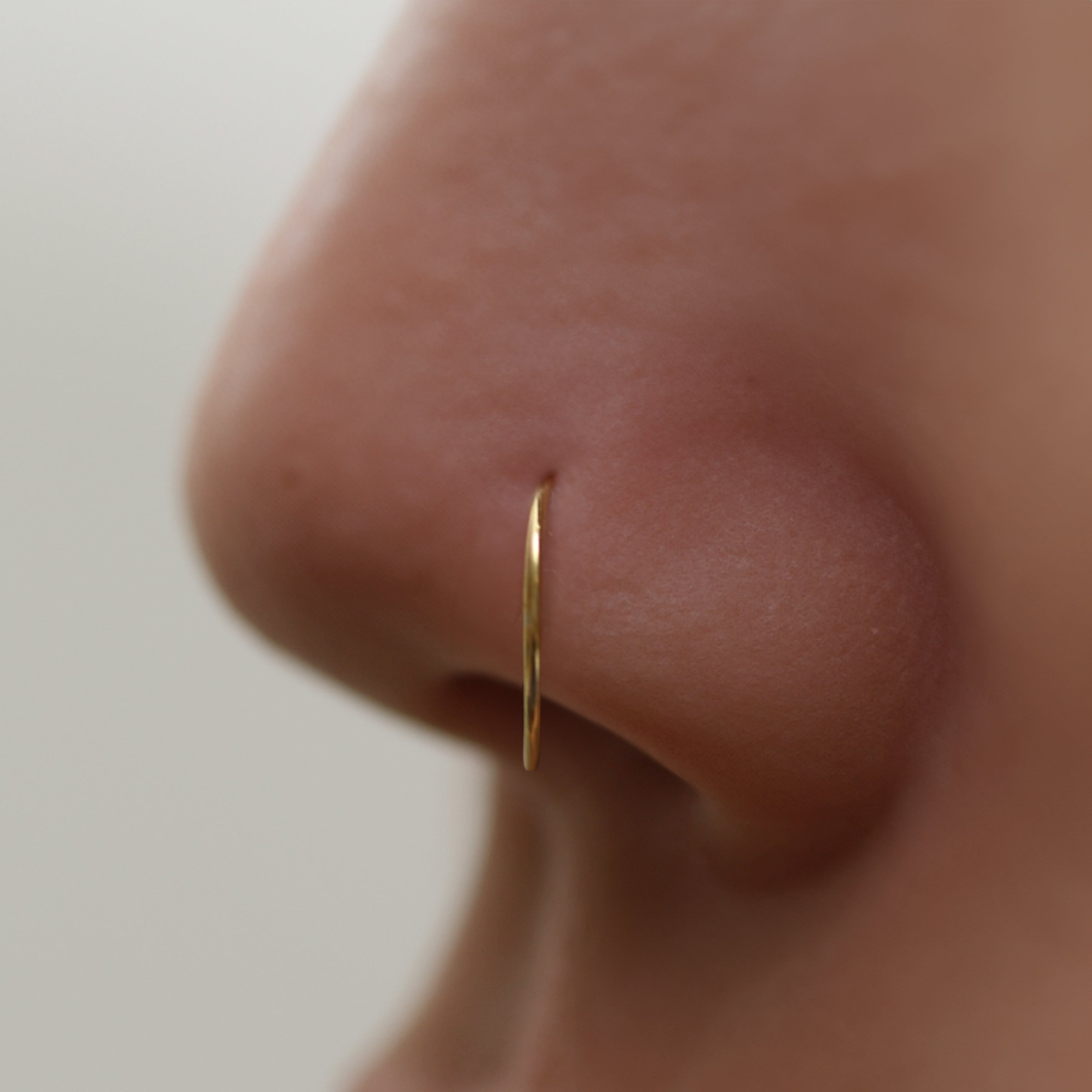 Tiny Nose Hoop featuring a sleek, minimalist design for subtle everyday elegance, offering a secure and comfortable fit for effortless, dainty style.