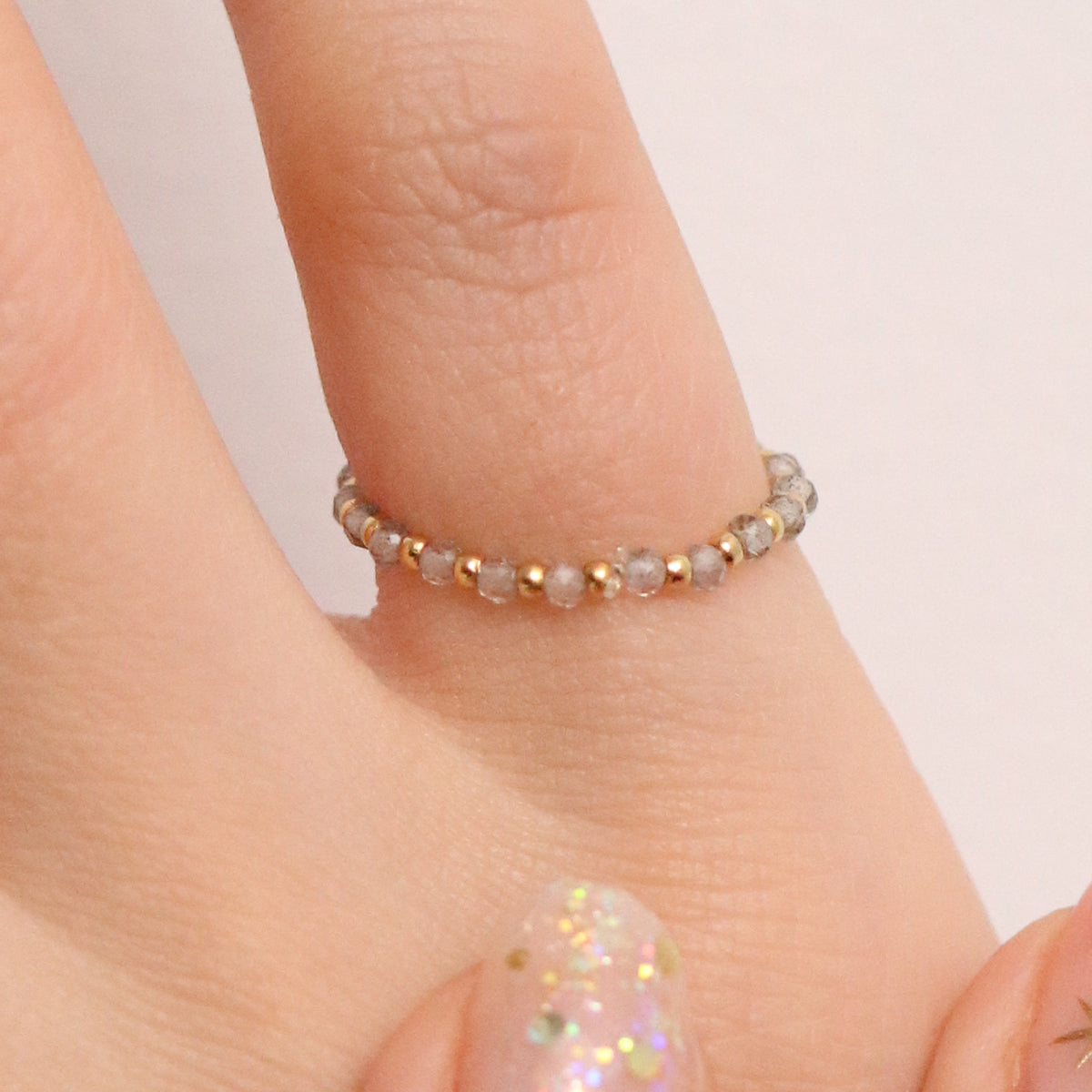 Stretchy Gemstone Ring featuring semi-precious gemstones and delicate sterling silver plated beads, offering a comfortable fit with a touch of refined elegance.