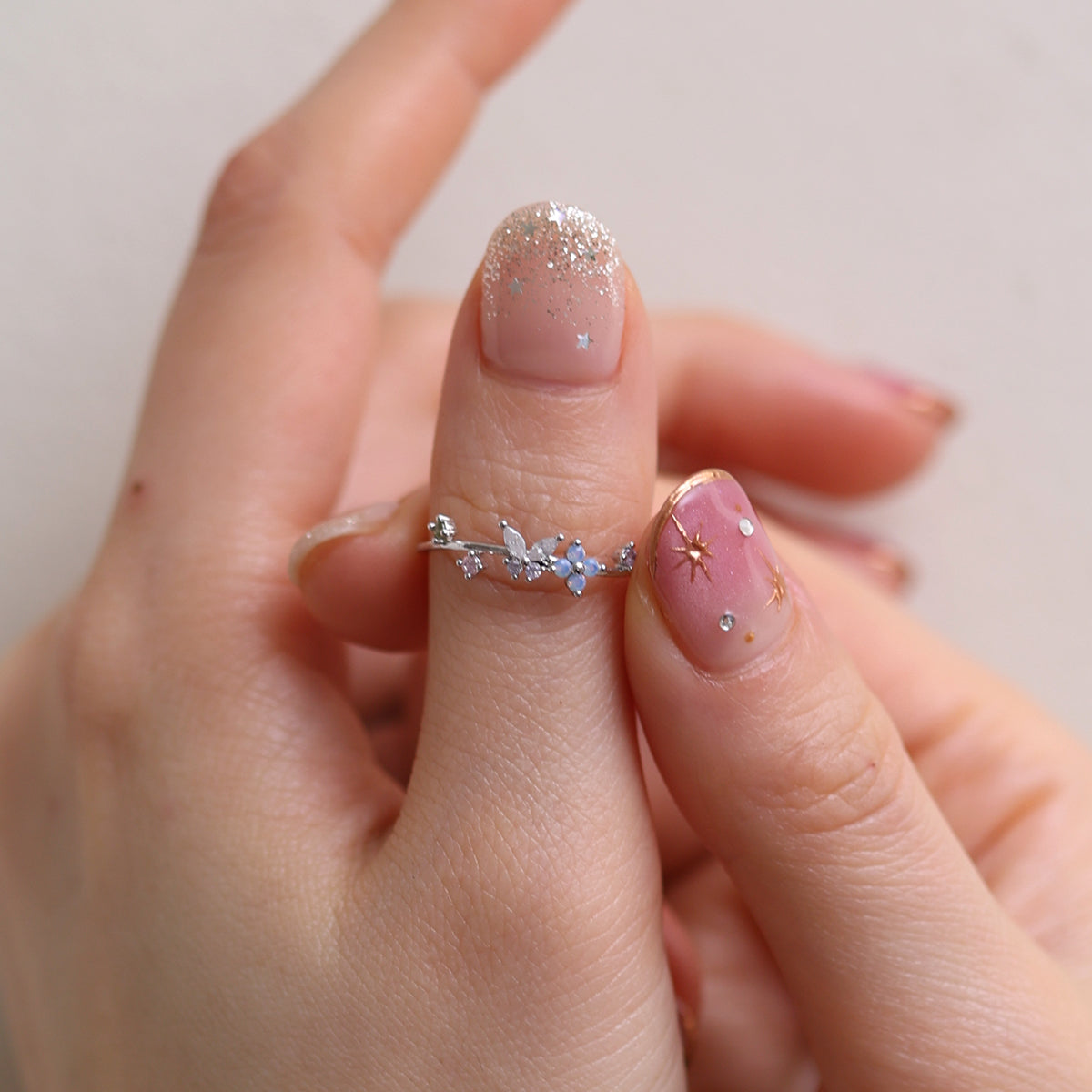 Butterfly Moonstone Flower Cubic Ring with a unique twist design and adjustable fit, combining layered elegance and modern style for any occasion.