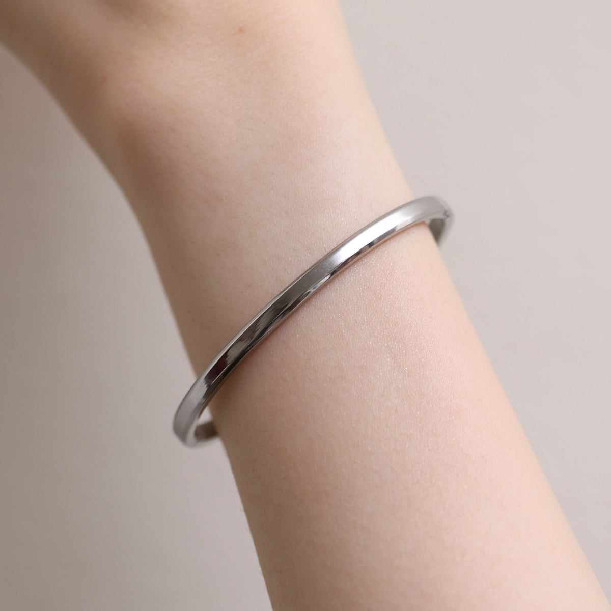 Thin Bangle featuring a precision-crafted, minimalist design with a slender profile, offering versatile style and durable elegance for any occasion.