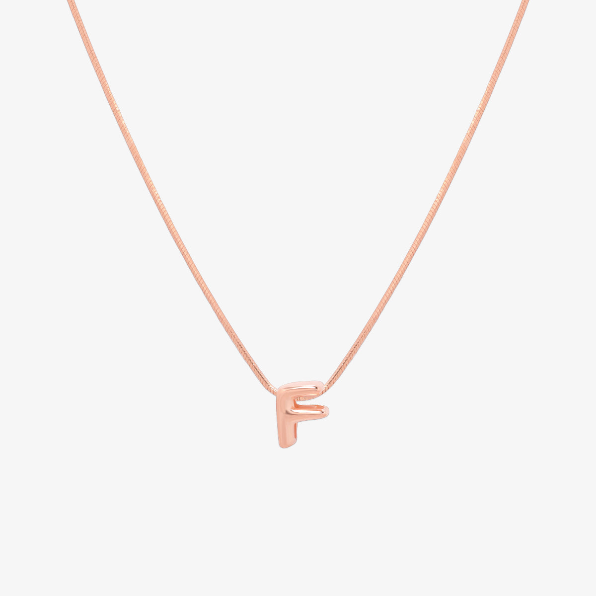 Bubble initial pendant necklace featuring a rounded, playful letter charm on a sleek snake chain, with a smooth and glossy finish.