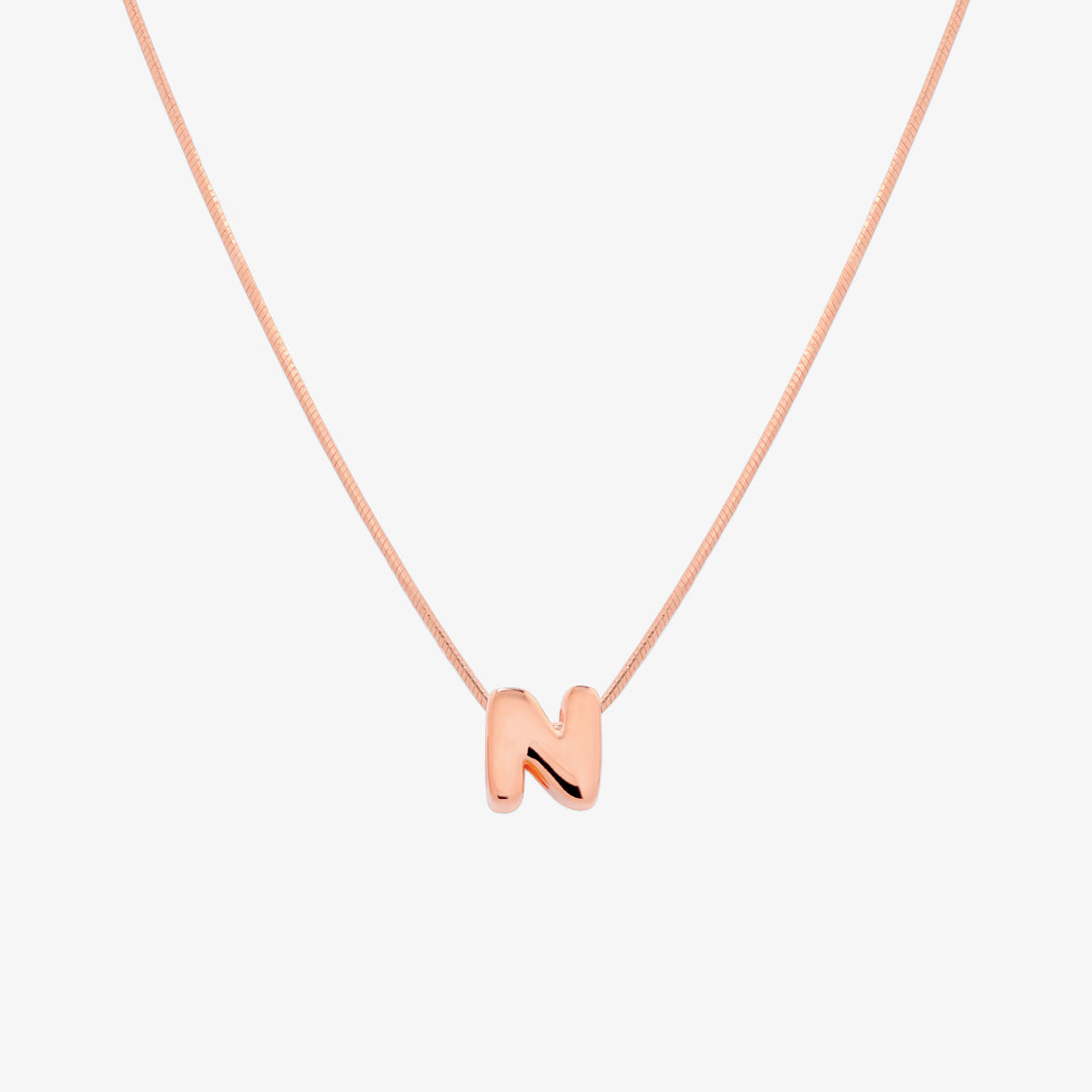 Bubble initial pendant necklace featuring a rounded, playful letter charm on a sleek snake chain, with a smooth and glossy finish.