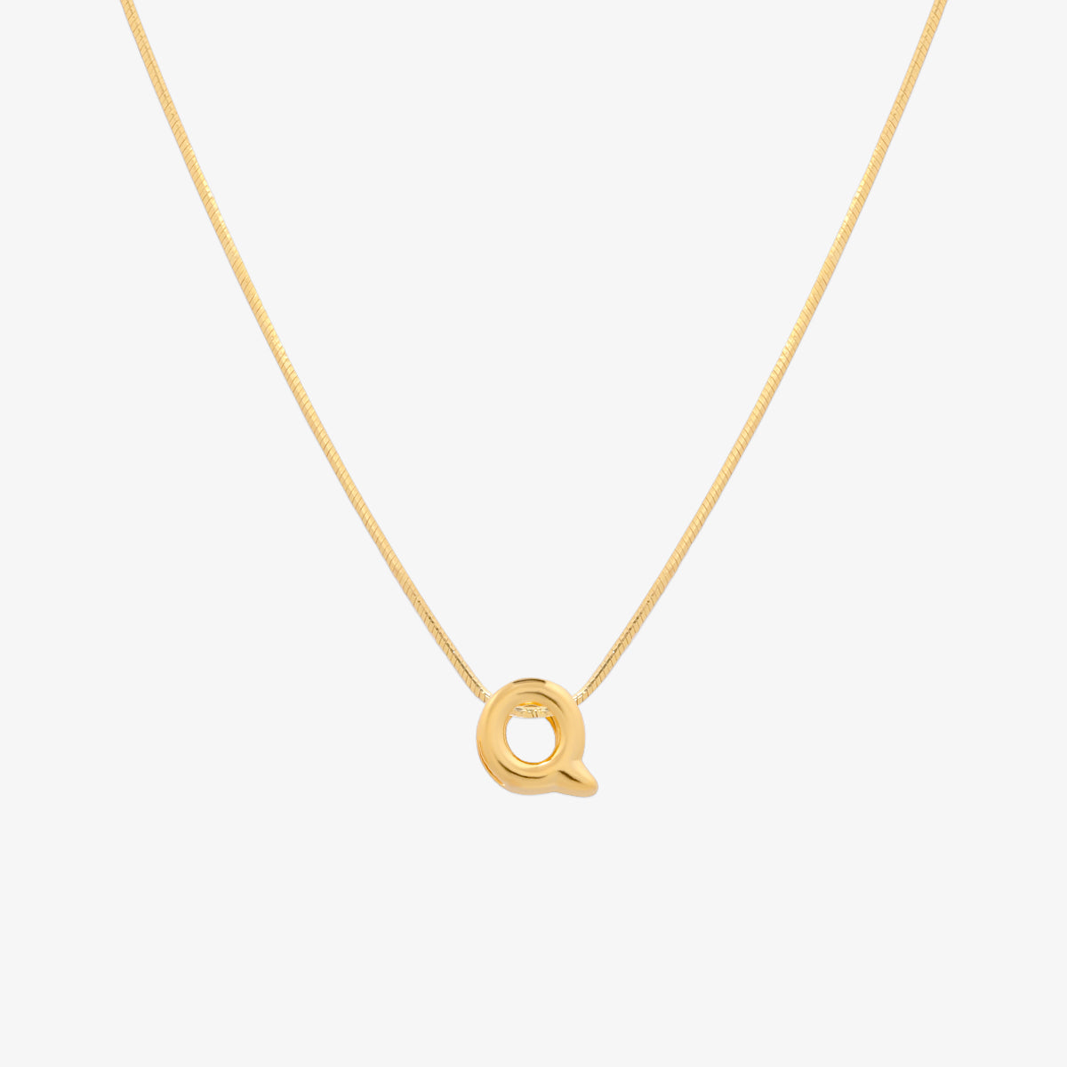 Bubble initial pendant necklace featuring a rounded, playful letter charm on a sleek snake chain, with a smooth and glossy finish.