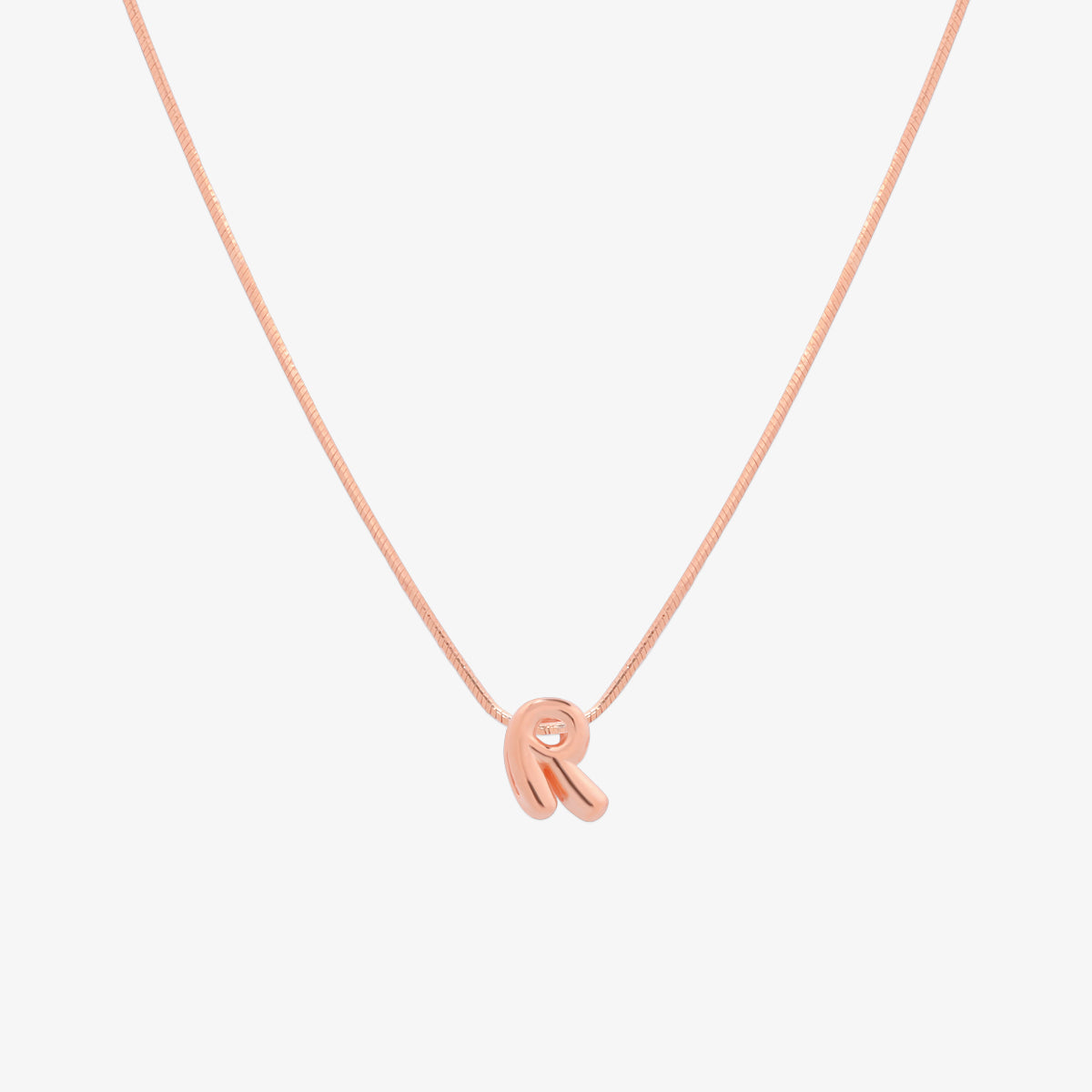 Bubble initial pendant necklace featuring a rounded, playful letter charm on a sleek snake chain, with a smooth and glossy finish.