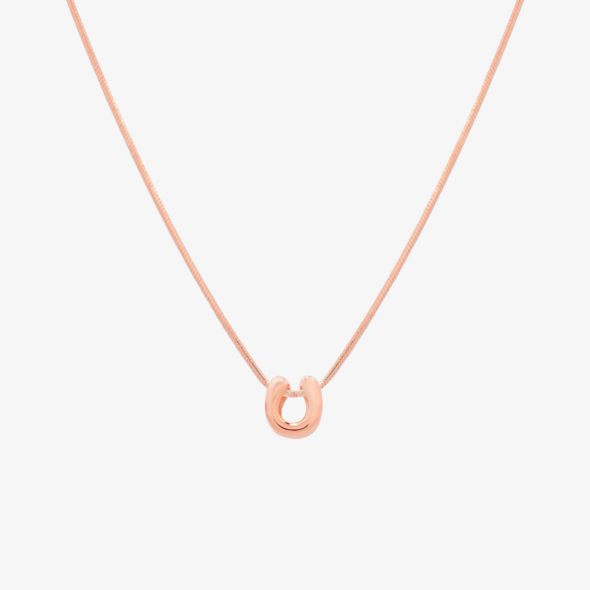 Bubble initial pendant necklace featuring a rounded, playful letter charm on a sleek snake chain, with a smooth and glossy finish.