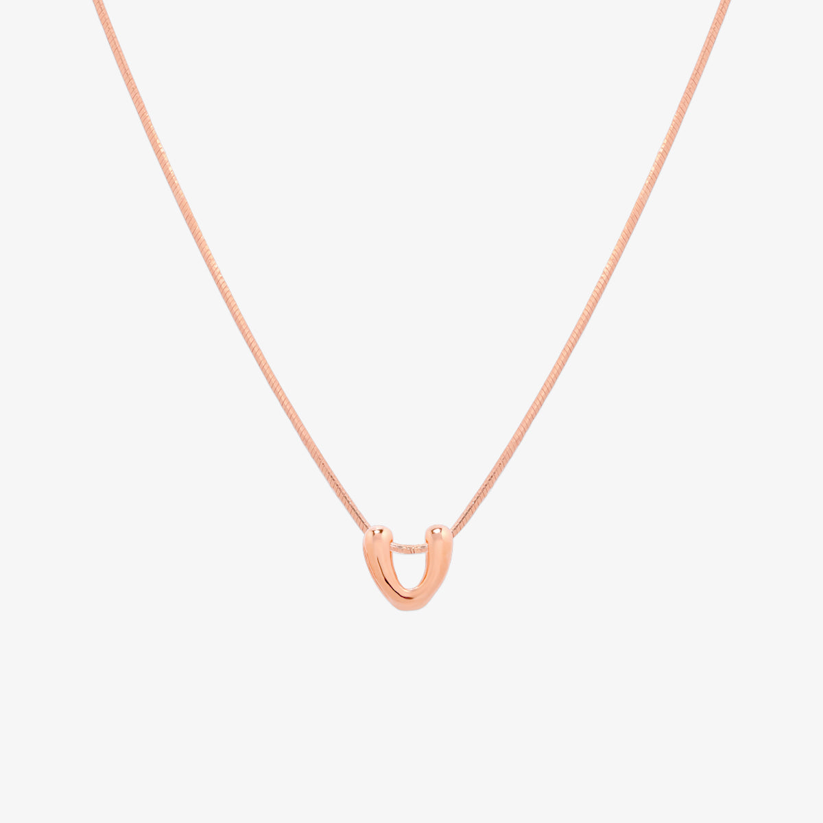 Bubble initial pendant necklace featuring a rounded, playful letter charm on a sleek snake chain, with a smooth and glossy finish.