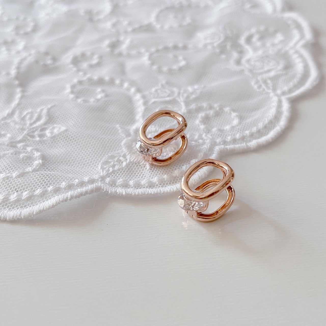 Cubic oval huggie earrings