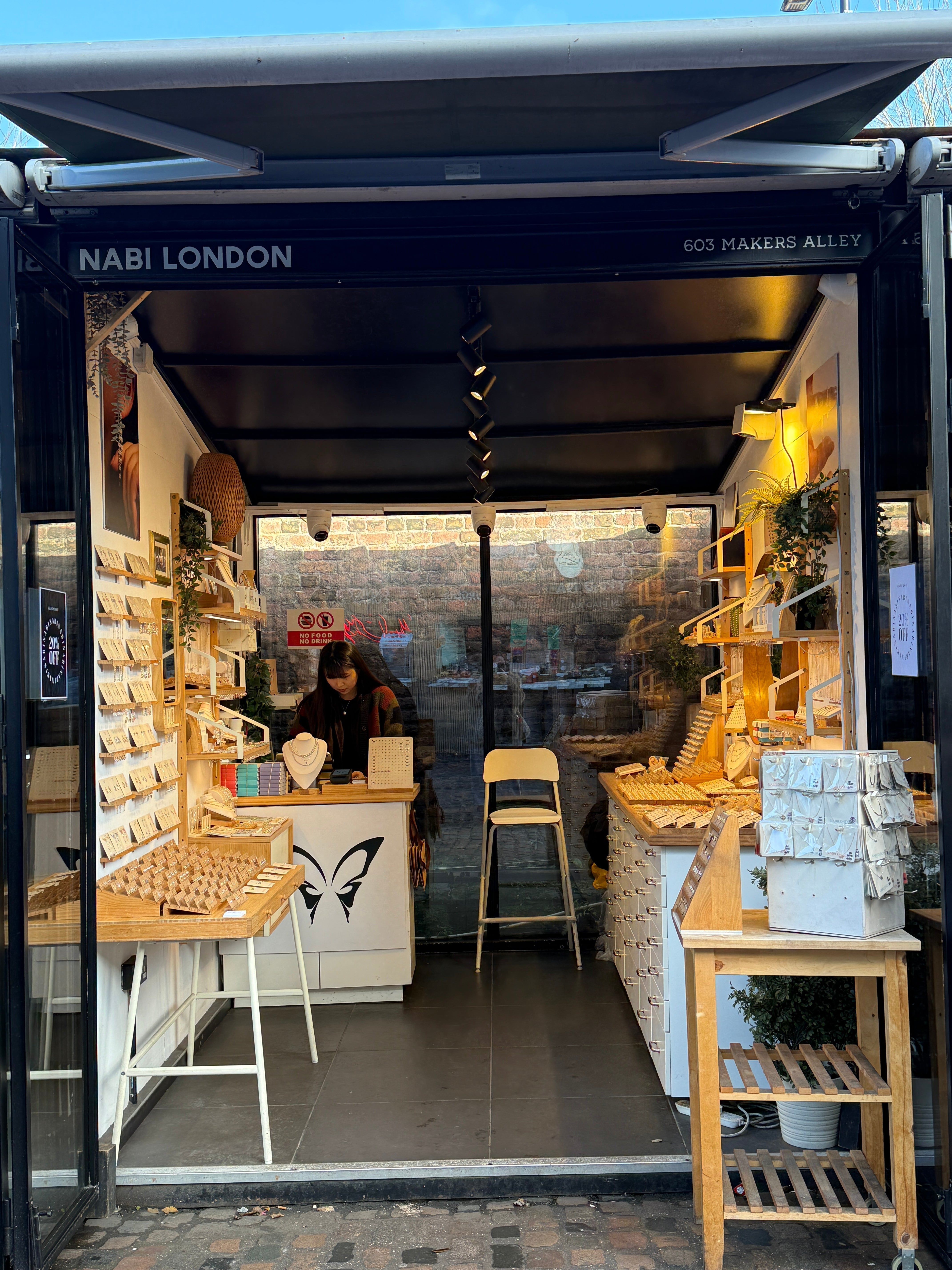 Nabilondon shop front at Camden Stables Market, showcasing a beautifully arranged display of dainty jewellery. A charming and inviting space filled with elegant, contemporary designs.