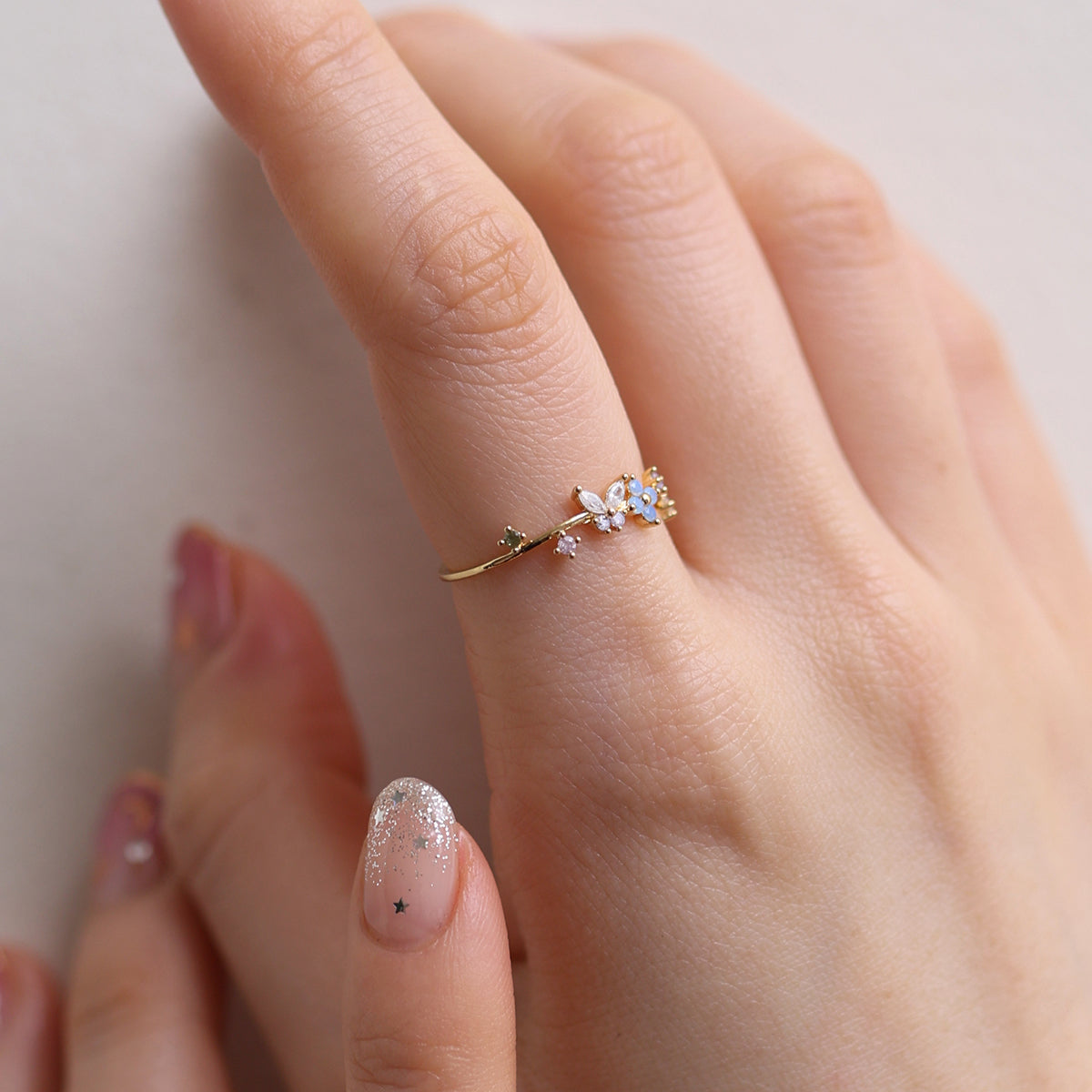 Butterfly Moonstone Flower Cubic Ring with a unique twist design and adjustable fit, combining layered elegance and modern style for any occasion.